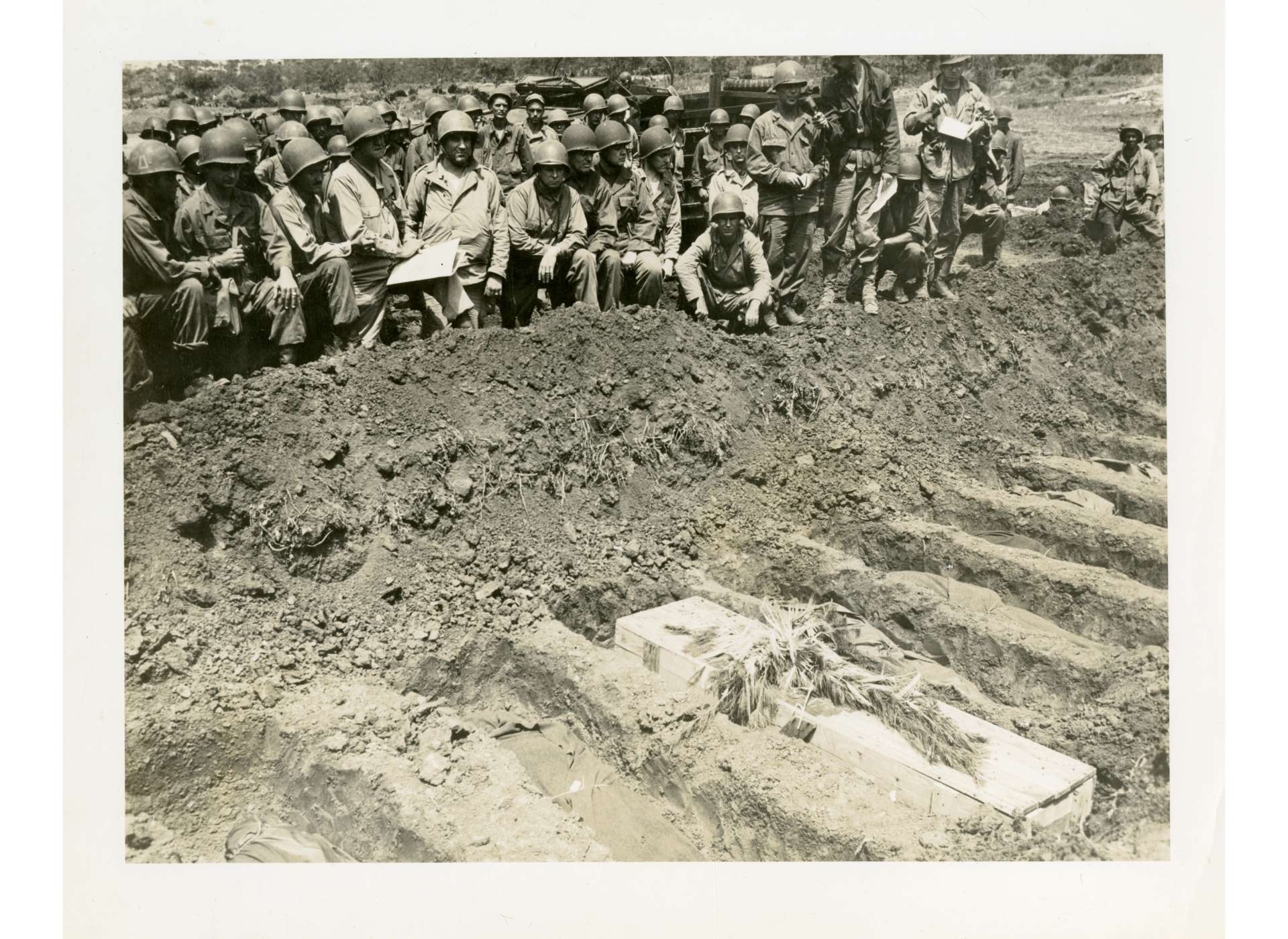 Members of the 77th Infantry Division gather around Ernie Pyle&#039;s first gravesite on Ie Shima to pay their respects. The National WWII Museum, Gift of Ralph F. Feuchter, Jr., 2013.436.002.