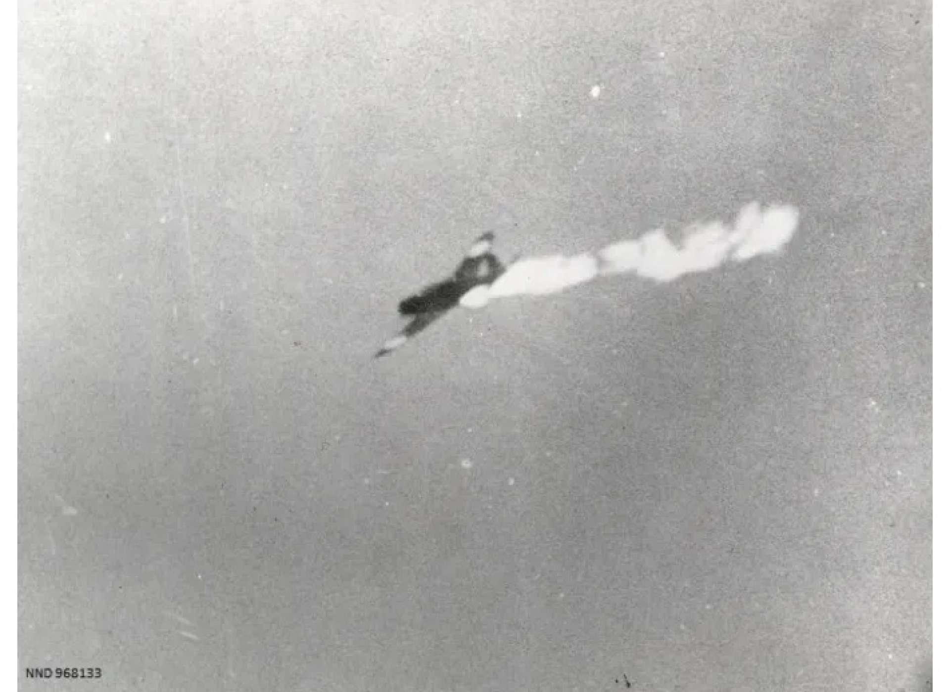 Japanese airplane after being hit by American fire. Photo courtesy of the National Archives and Records Administration.