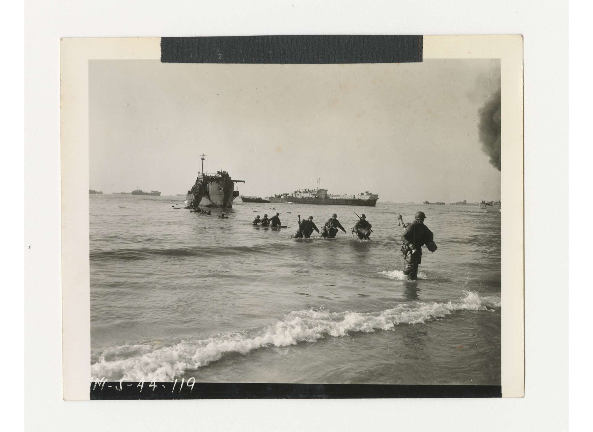 Troops of US Fifth Army come ashore at Anzio, January 23, 1944. Gift of Ms. Regan Forrester, from the Collection of The National WWII Museum, 2002.337.066.