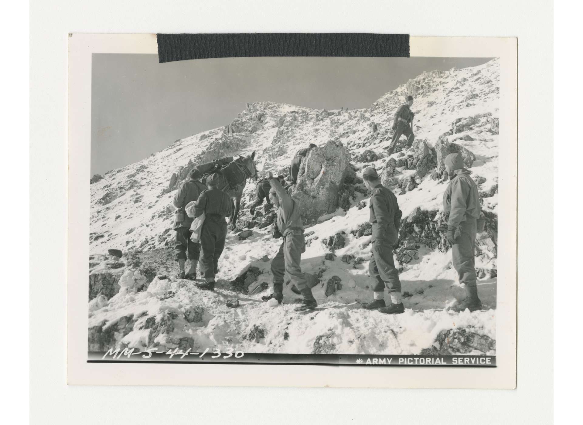 Members of the Polish Carpathian Division with pack mule navigate a mountainous area, February 18, 1944. US Army Signal Corps photo, gift of Ms. Regan Forrester, from the Collection of The National WWII Museum, 2002.337.123.