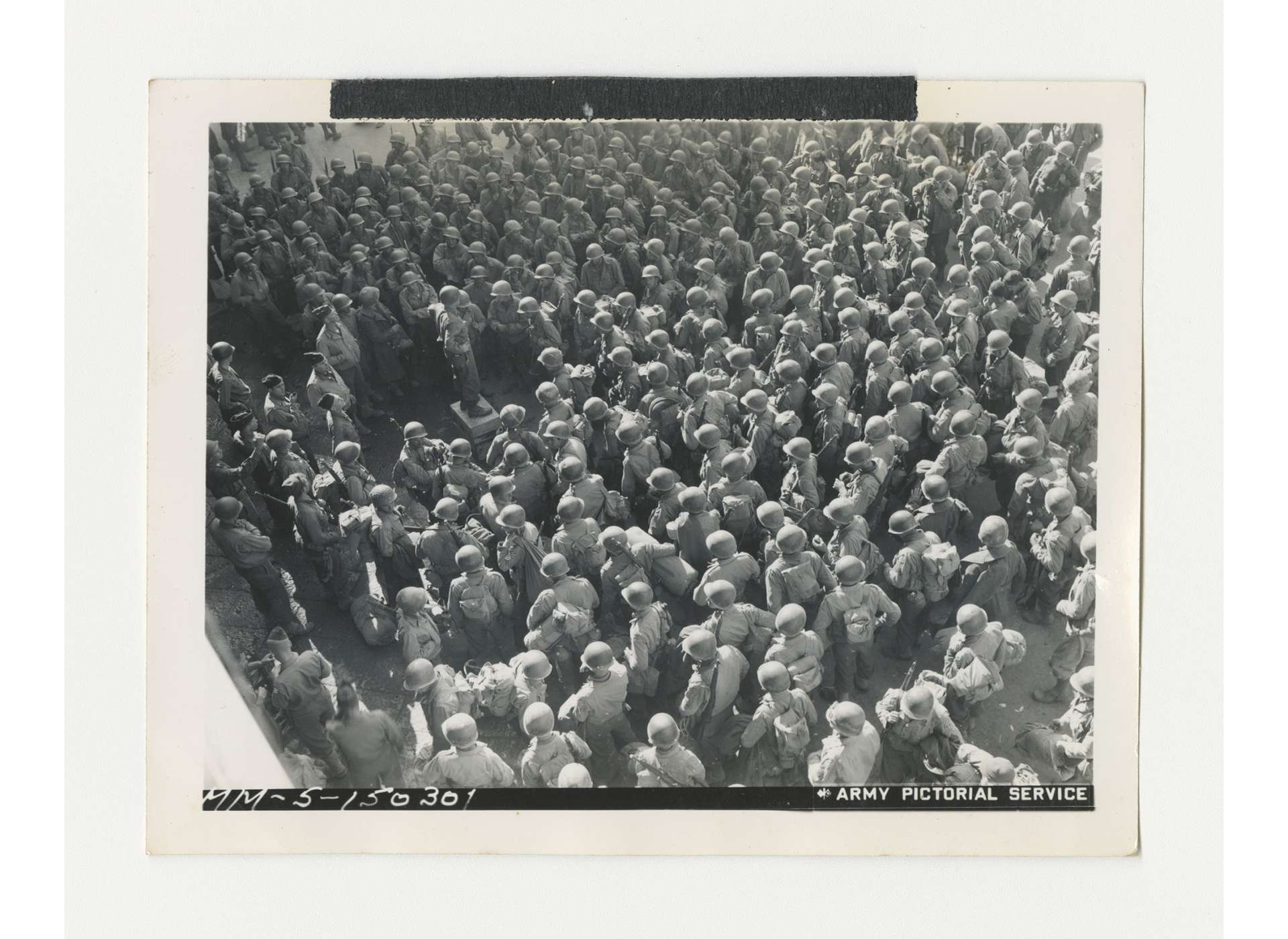 Hundreds of American soldiers assemble at a rest camp near Naples and listen to update, Fall 1943. US Army Signal Corps photo, gift of Ms. Regan Forrester, from the Collection of The National WWII Museum, 2002.337.236.