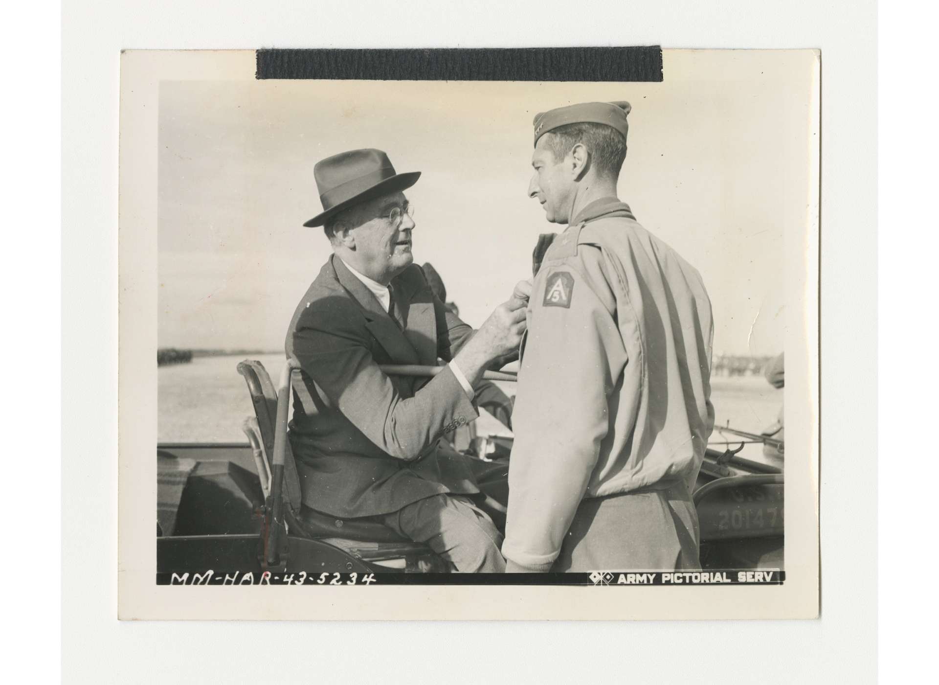 President Franklin D. Roosevelt pins the Distinguished Service Cross on General Mark Clark, commander of US Fifth Army, at Castelvetrano, Sicily, December 10, 1943. US Army Signal Corps photo, gift of Ms. Regan Forrester, from the Collection of The National WWII Museum, 2002.337.423.