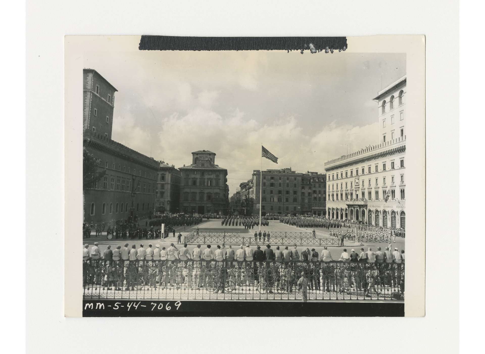 Troops of US 2nd Battalion, 338th Infantry Regiment, 85th Infantry Division, gather in the Piazza Venezia in Rome for an Independence Day retreat ceremony to lower the American flag flying over Rome. The flag had flown over the White House on December 7, 1941. US Army Signal Corps photo, gift of Ms. Regan Forrester, from the Collection of The National WWII Museum, 2002.337.658.