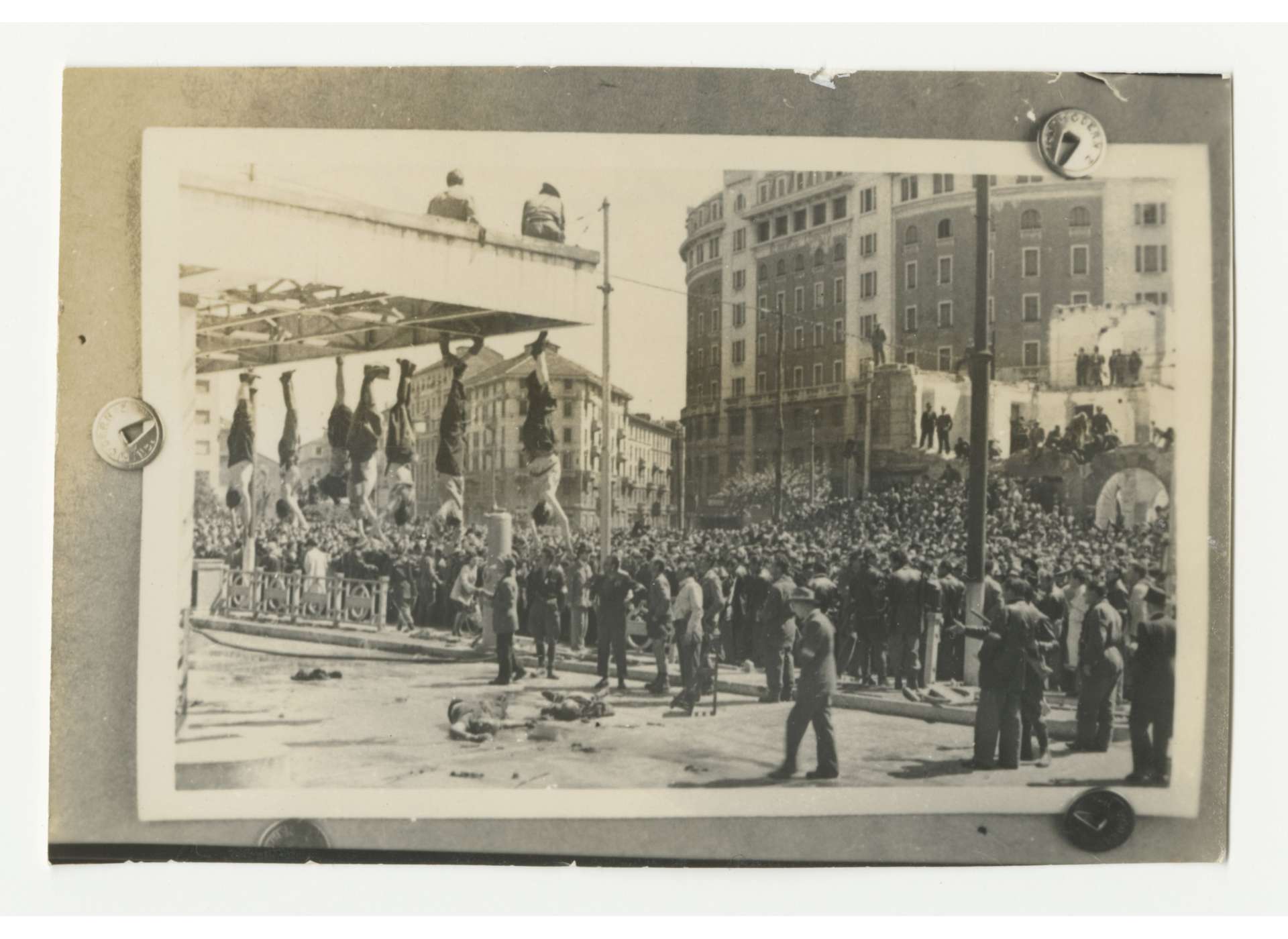 Corpses of Benito Mussolini and his compatriots exhibited at the Piazzale Loreto in Milan, April 29, 1945. Gift of Dorothy Poitevent, from the Collection of The National WWII Museum, 2007.243.189.