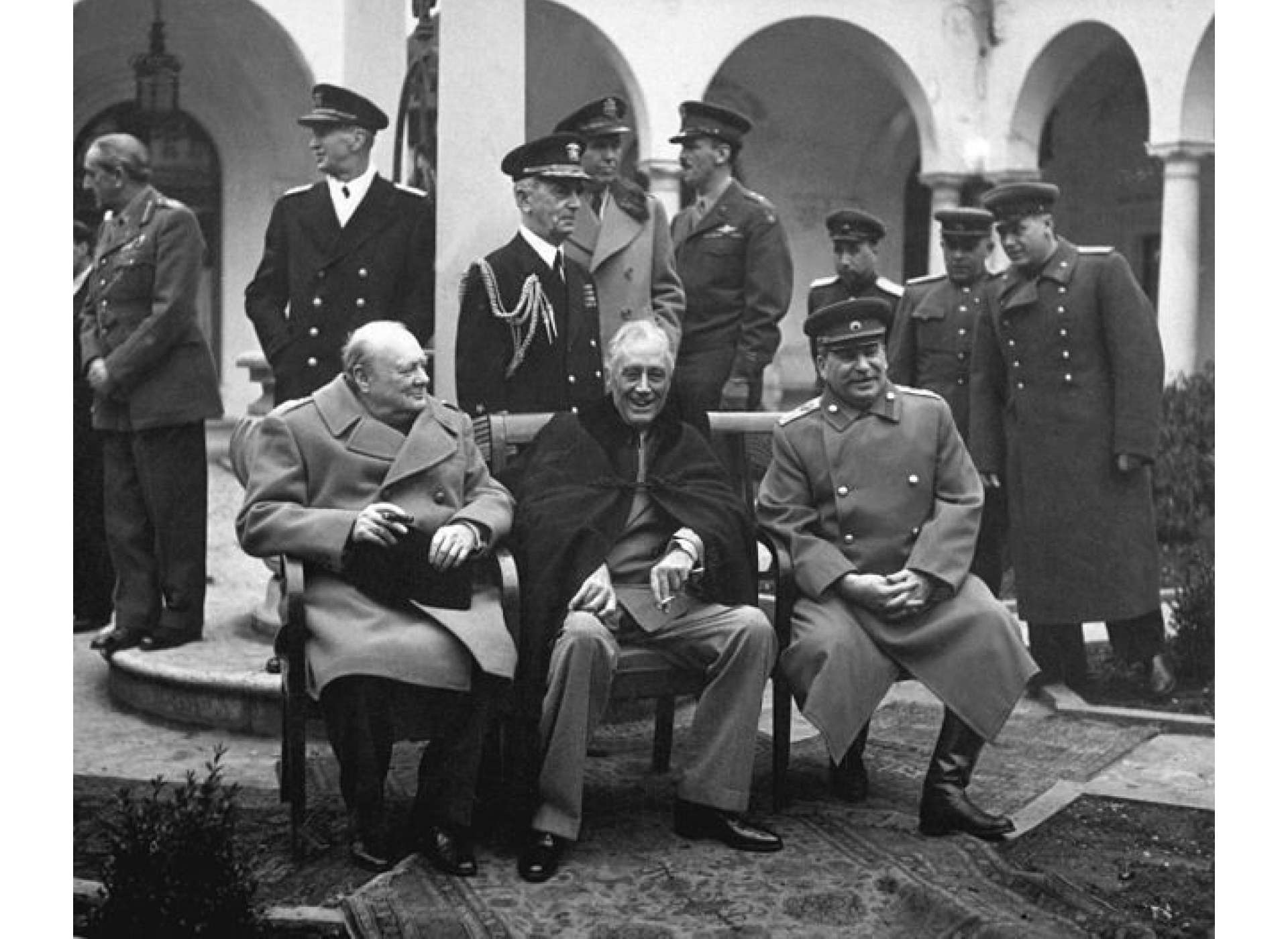 British Prime Minister Winston Churchill, U.S. President Franklin D. Roosevelt, and Soviet Premier Joseph Stalin pose outside on the grounds of the Livadia Palace during the Yalta Conference. “Yalta Conference, February 4, 1945, Yalta, Ukraine, United States Holocaust Memorial Museum, courtesy of National Archives and Records Administration, College Park, Photograph Number: 91461.