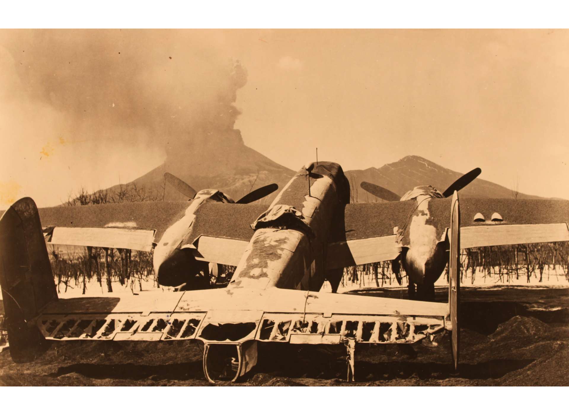 In the shadow of Mount Vesuvius, the wreckage of a charred 340th Bombardment Group B-25 Mitchell lies in the ashes of Pompeii Airfield. Courtesy National Archives.