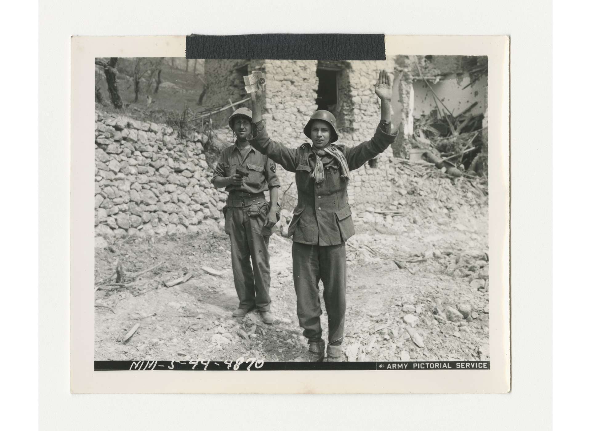 Moroccan soldier, part of Free French forces, guards a German prisoner of war in the Castelforte area, May 15, 1944. US Army Signal Corps photo, gift of Ms. Regan Forrester, from the Collection of The National WWII Museum, 2002.337.187.