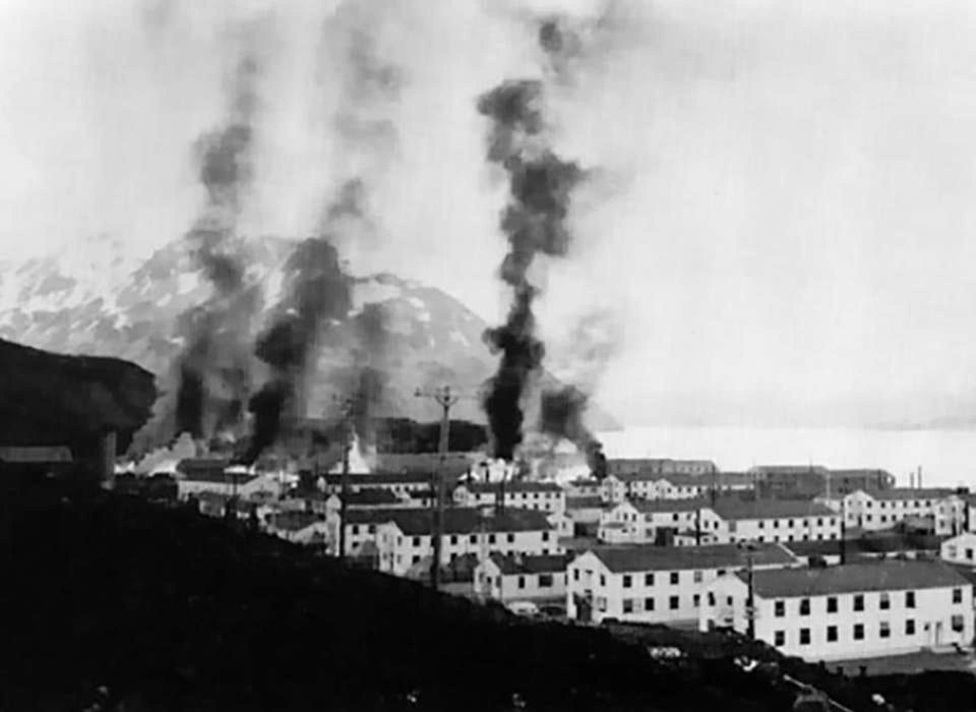 Barracks buildings at For Mears burn following the Japanese attack on June 3, 1942. Courtesy of the National Archives and Records Administration.