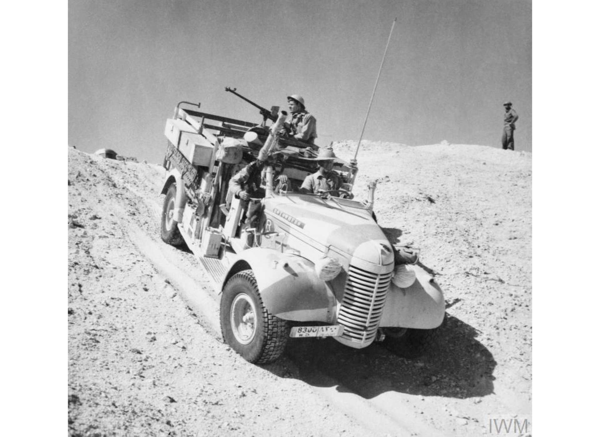 A Long Range Desert Group Chevrolet 30cwt truck negotiates the slope of a sand dune during a patrol in the desert, 27 March 1941. Note the Boys Anti Tank rifle.