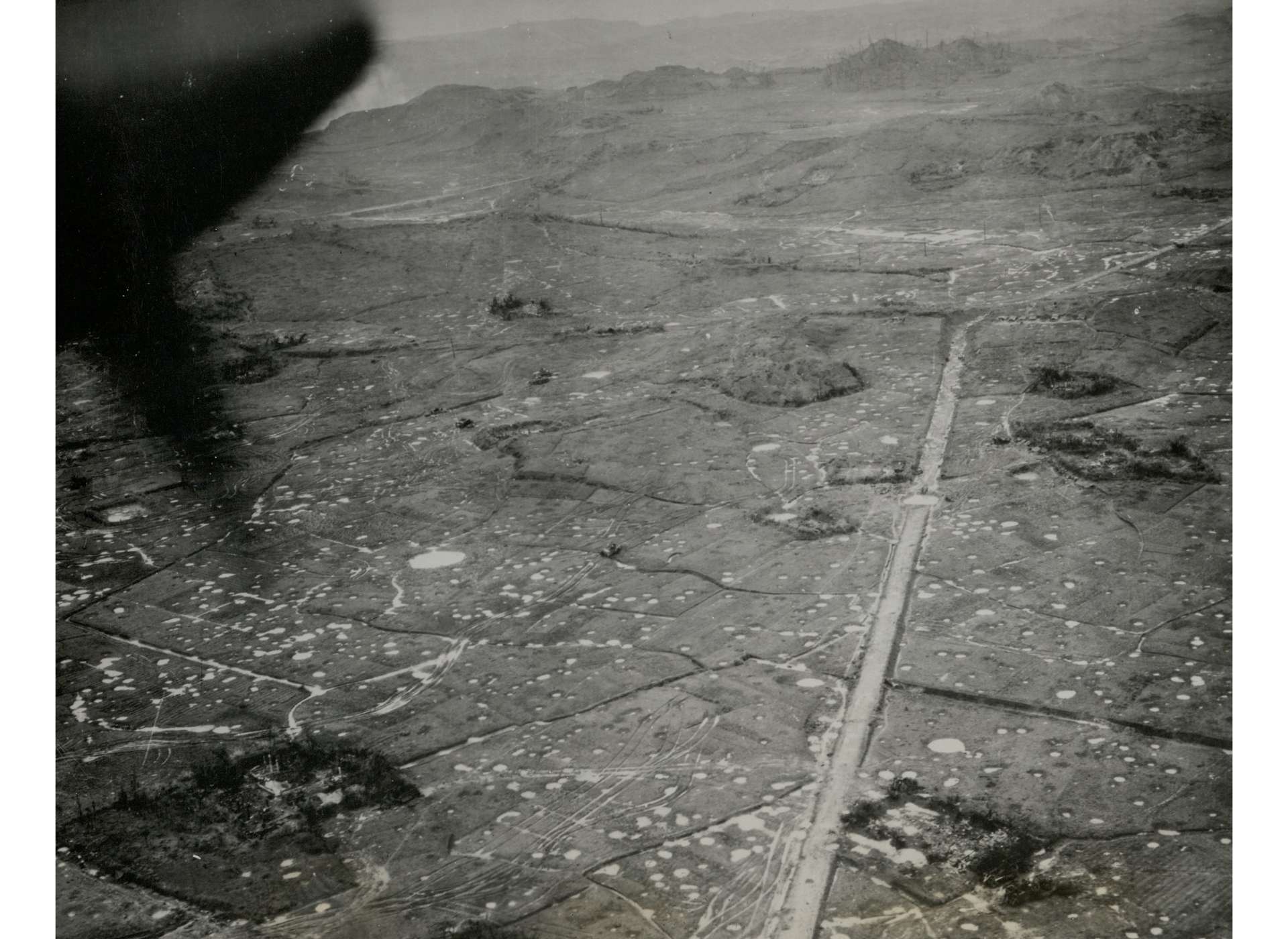 Fighting on Okinawa left much of the southern half of the island a disfigured and cratered wasteland. US Army official photograph. The National WWII Museum, Gift of Dylan Utley, Accession #2012.019.400