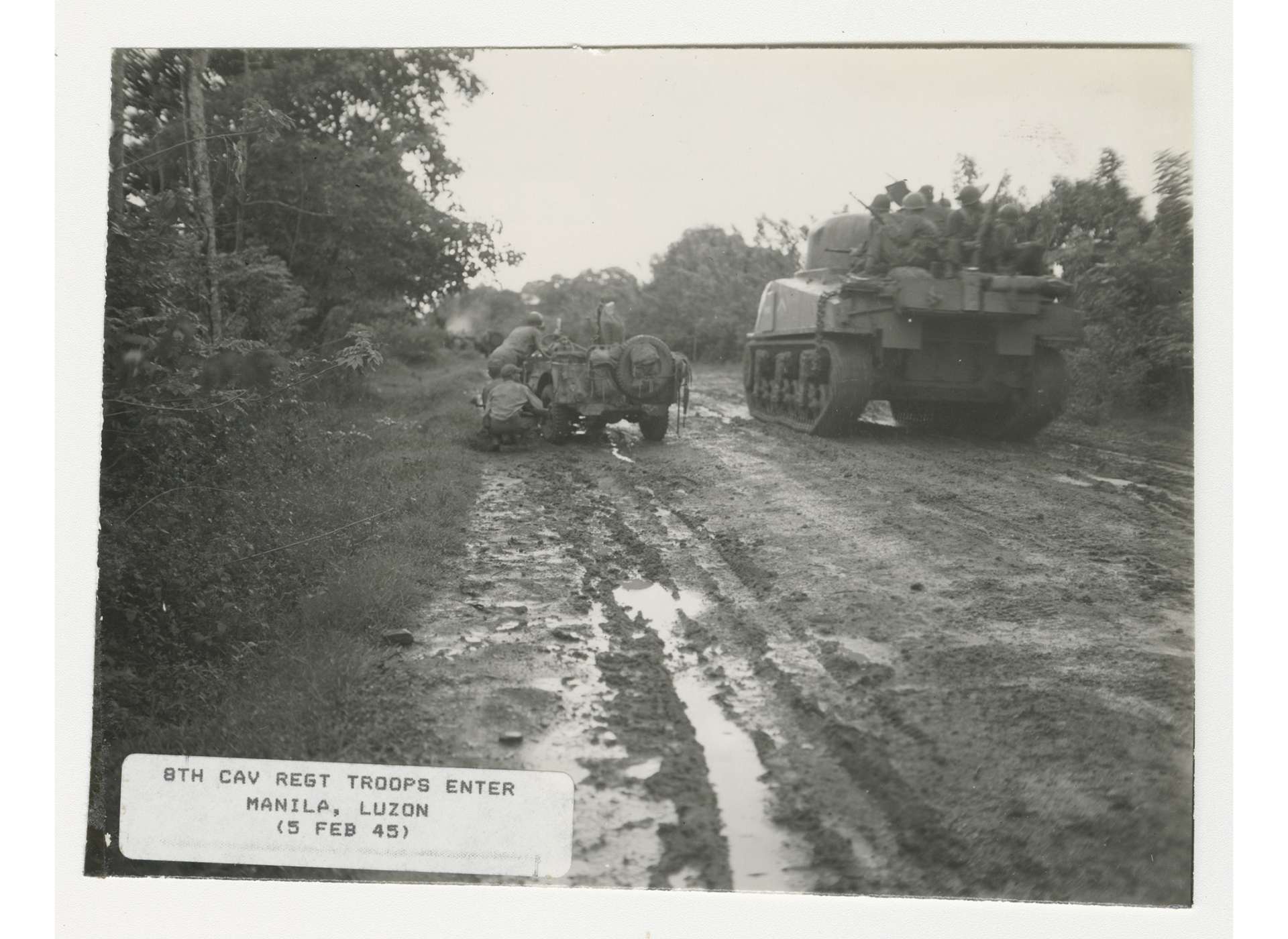 Troopers of the 8th Cavalry’s “flying column” supported by tanks raced to reach Manila on February 3, 1945 and free the internees at Santo Tomas University. US Army Signal Corps Photograph, Gift of Donald E. Mittelstaedt, from the Collection of The National World War II Museum, 2008.354.495.