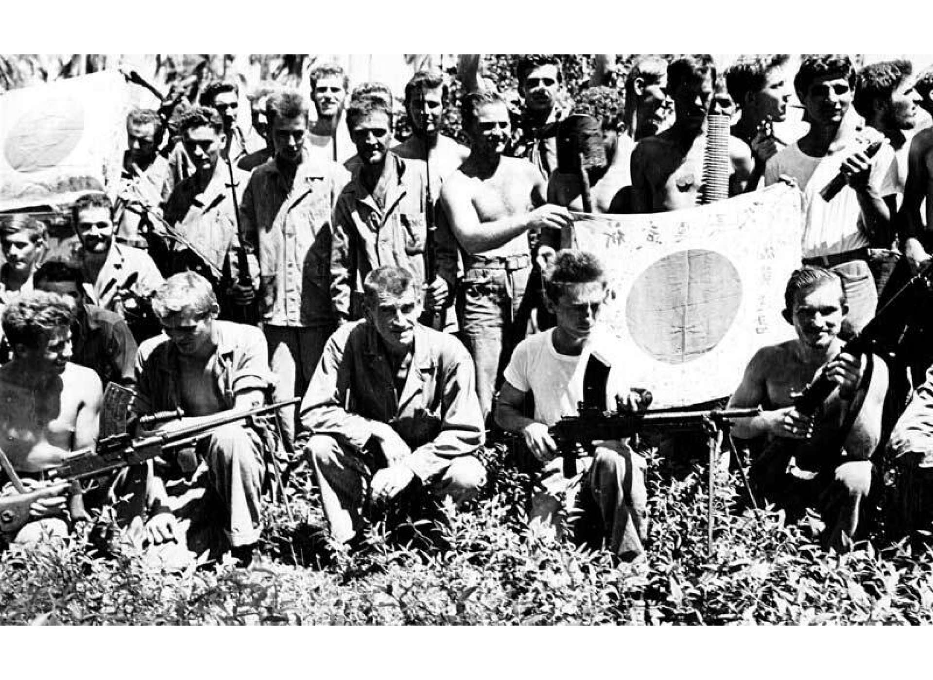 Carlson’s Raiders with their trophies, including Japanese Type 96 machine guns and flags, courtesy of the National WWII Museum.