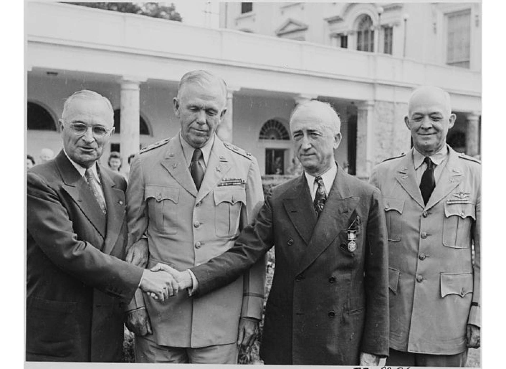 “Photograph of President Truman shaking hands with Secretary of State James F. Byrnes after awarding him the Distinguished Service Medal,” August 13, 1945, National Archives and Records Administration, Office of Presidential Libraries, Harry S. Truman Library, (NAID) 199180.