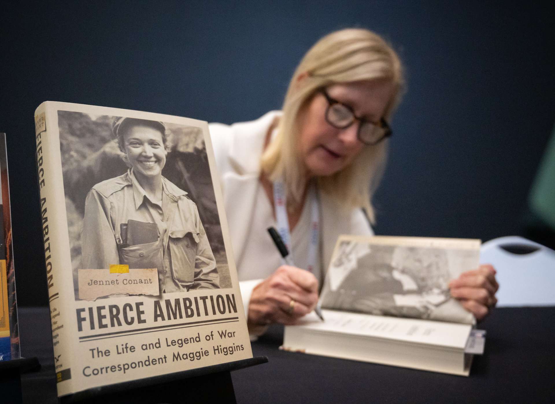 Closing speaker Jennet Conant signs copies of her recent publication, Fierce Ambition,