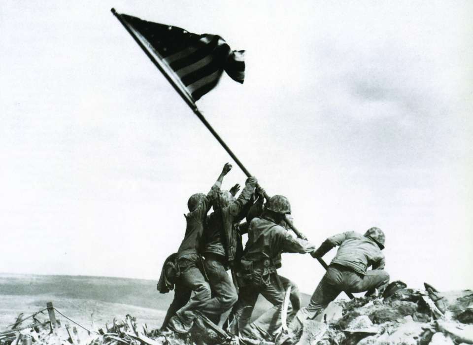 Iconic Iwo Jima flag raising with soldiers raising the American flag