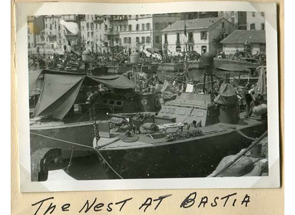 PT boats of Squadron 15 and 22 “nested” in the harbor of Bastia, Corsica. Patrolling only at night meant that PT crews rested and worked on their boats during the day. Gift In Memory of Edric G. Costain. 2010.152