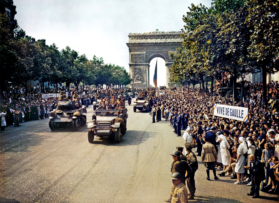 Crowds of French patriots line the Champs-Élysées to view Free French tanks and halftracks 