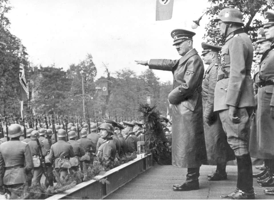 Adolf Hitler receives a parade of German troops in Warsaw