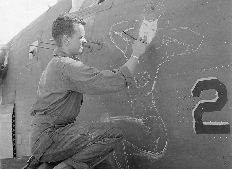 Sgt. J.S. Wilson, USA, painting a design of prow of a bomber