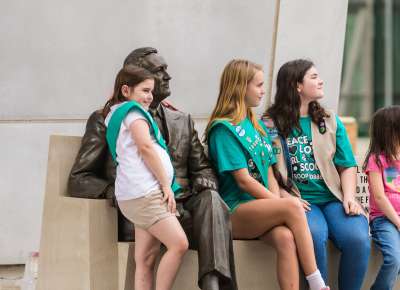 Kids and family posing with FDR statue at The National WWII Museum