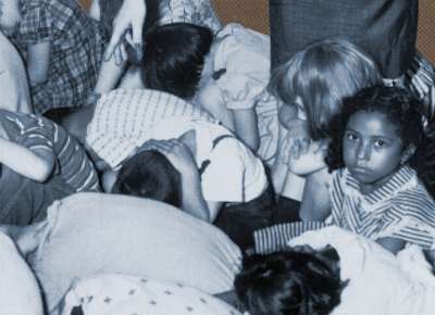 Children cover their heads in a drill at school