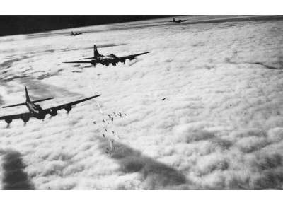Boeing B-17s releasing their bombs on a flare path from a pathfinder aircraft. From the 482 Bomb Group, USAAF Archives.