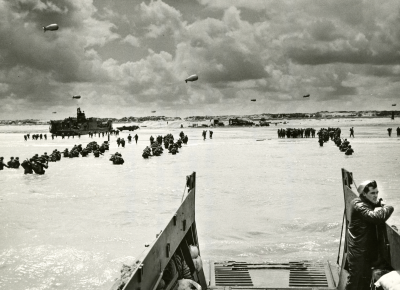 US Forces gathering on a Normandy Beach after D-Day, France 1944