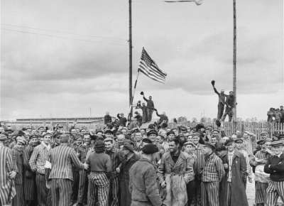 Inmates waving a home-made American flag greet U.S. Seventh Army troops